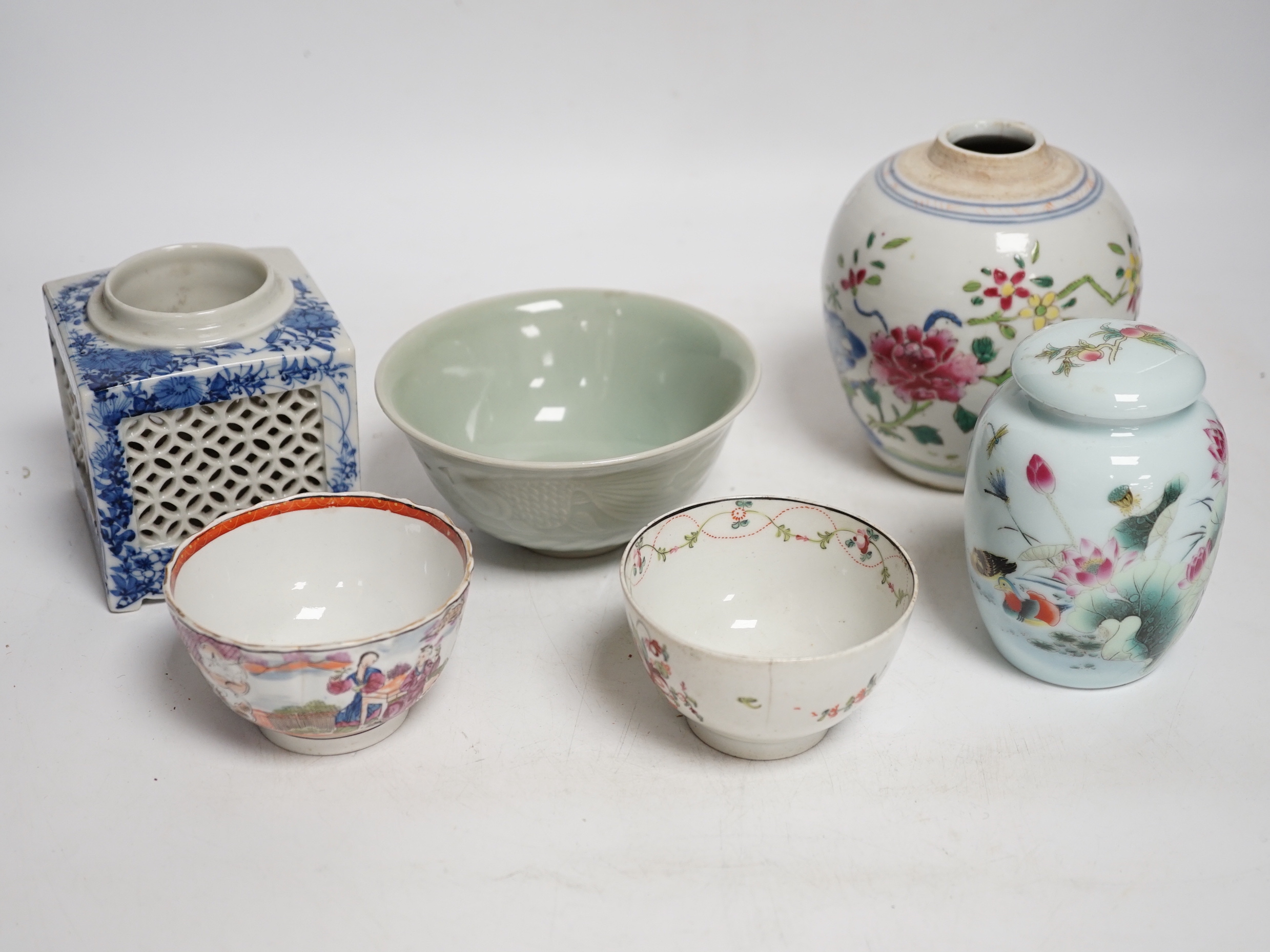 A collection of Chinese ceramics including celadon bowl decorated in low relief with fish, famille rose tea bowls and a jar, largest 12cm high